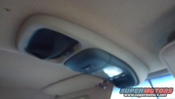 Overhead console in a 1996 Ford Bronco with two dark compartments and illuminated lights