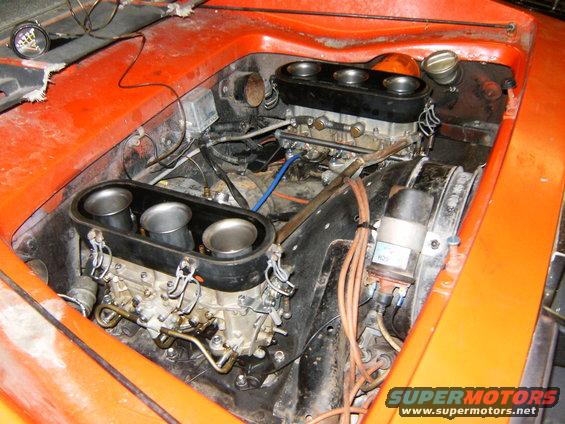 Engine bay with dual Weber carburetors and intake trumpets