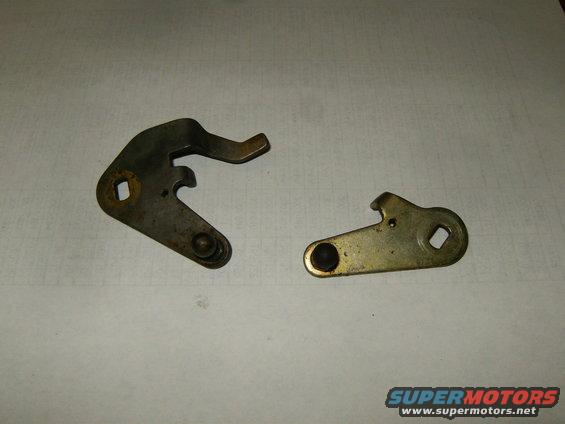 Two metal levers with pivot points and notches, one darker than the other