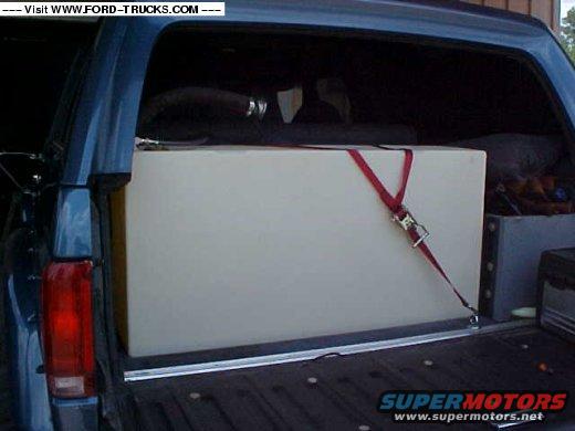 Rear view of a 1992 Ford Bronco with a large white tank secured in the cargo area