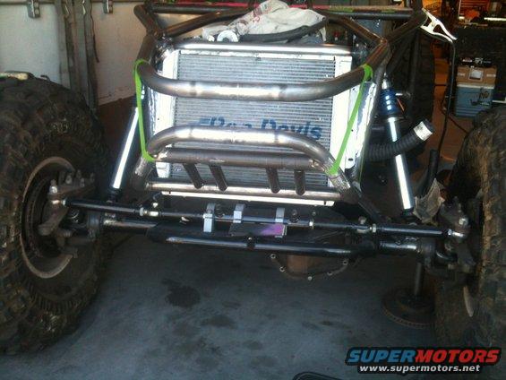 Off-road buggy chassis with large radiator, exposed suspension, and large tires