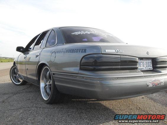 1995 Ford Crown Victoria rear quarter with custom taillights and aftermarket wheels