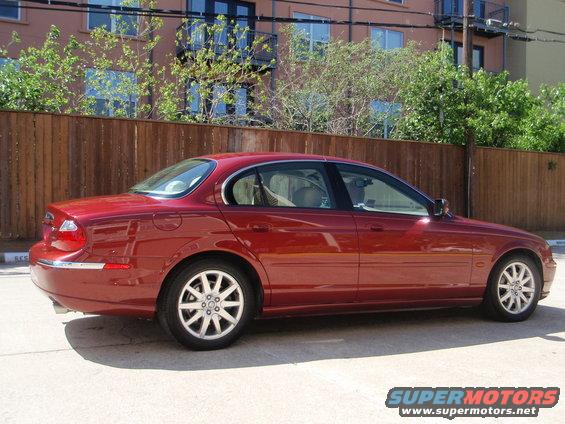 Red 2000 Jaguar S-Type sedan, side view