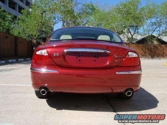 Rear view of a red Jaguar S-Type with '3.0' and 'S-Type' badges visible