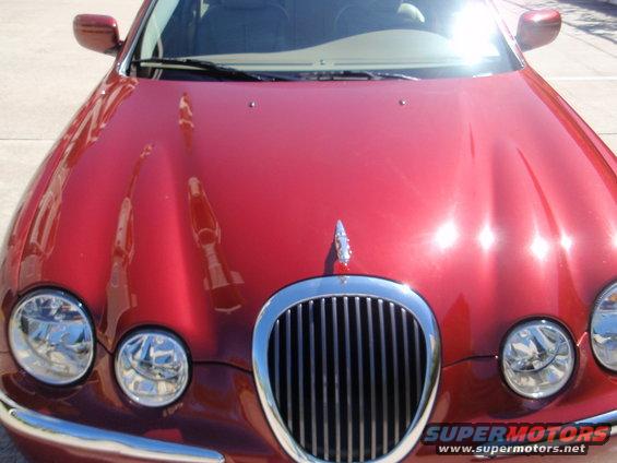 Front view of a red 2000 Jaguar S-Type with chrome grille and headlights