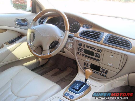 Interior of a 2000 Jaguar S-Type showing the dashboard, steering wheel, and center console