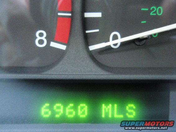 Car dashboard with speedometer and odometer showing 6960 miles