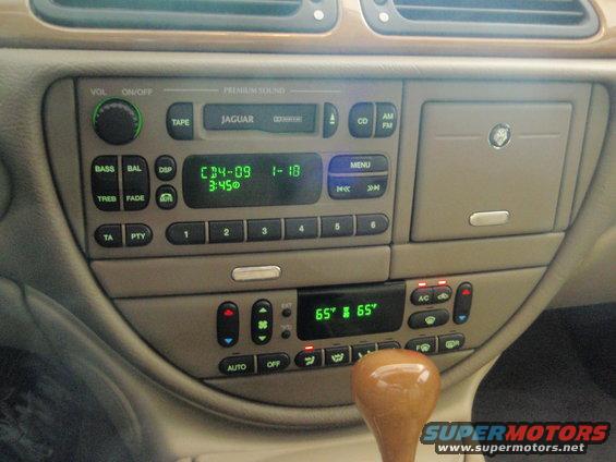 Jaguar S-Type interior dashboard with radio, climate controls, and gear shift