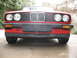 1986 BMW 3 Series - Front view of a red 1986 BMW 3 Series, its iconic grille and dual headlights.