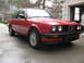 1986 BMW 3 Series - Red 1986 BMW 3 Series coupe with a black grille and chrome trim.