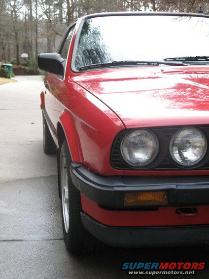 Red 1986 BMW 3 Series coupe parked on driveway, front quarter view