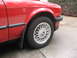 1986 BMW 3 Series - Close-up of the front fender and wheel of a red 1986 BMW 3 Series.