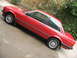 1986 BMW 3 Series - A red 1986 BMW 3 Series coupe is shown from a 3/4 front angle, parked on a paved surface.