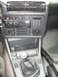 1986 BMW 3 Series - The interior of a 1986 BMW 3 Series features a manual transmission and an aftermarket Kenwood stereo system.