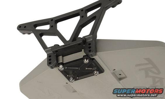 Black plastic wing mount attached to a gray RC car body. Text 'SUPERMOTORS' visible