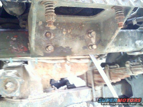 Close-up of rusty springs and bolts on a heavy duty truck's suspension system