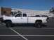 1997 Dodge 3500 - This white dually pickup truck is parked in a lot with other vehicles.