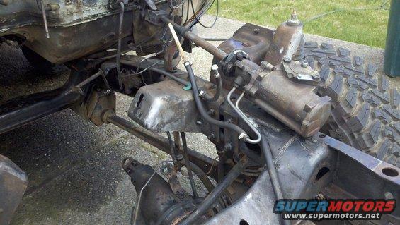 close-up of vehicle frame with steering box and suspension parts