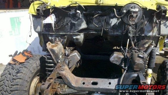 Yellow 1978 Ford Bronco chassis with engine and suspension visible