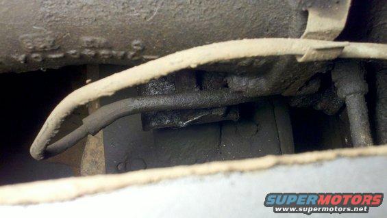 close-up of vehicle undercarriage with brake lines and frame