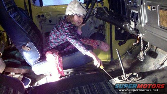 Child in 1978 Ford Bronco interior with screwdriver
