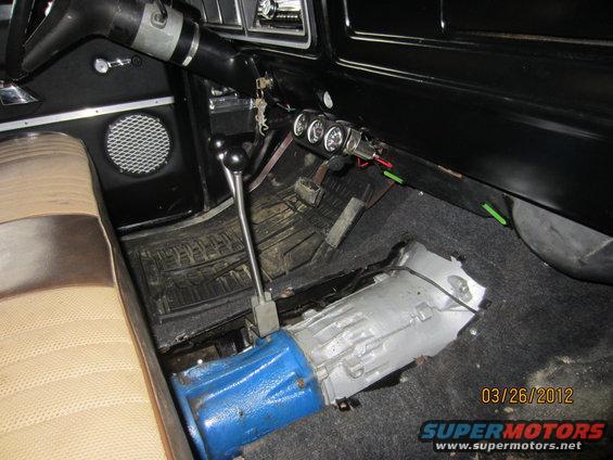 1979 Ford Bronco interior showing transmission and shifter removed, with auxiliary gauges mounted on dash