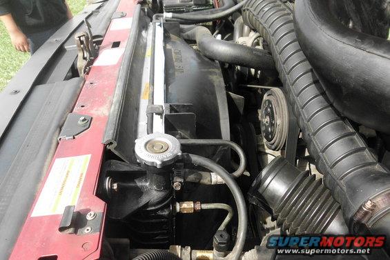 1994 Ford Bronco engine bay showing radiator, fan, and air intake hoses