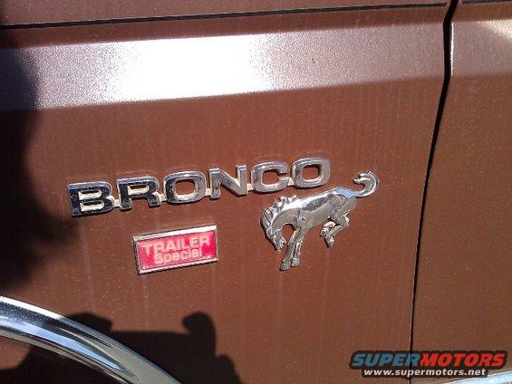 1981 Ford Bronco emblem with running horse and Trailer Special badge on brown body panel