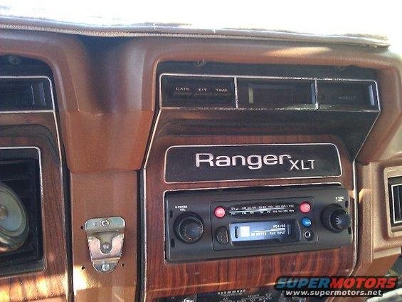 Dashboard with woodgrain trim, a Ranger XLT badge, and an aftermarket radio
