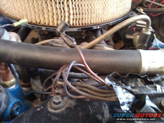Close-up of engine bay showing air filter, hoses, and wiring harness