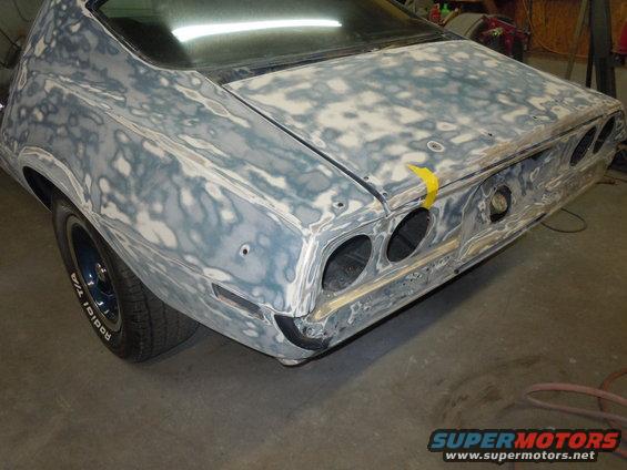 Rear of a 1973 Chevrolet Camaro with body filler and primer, showing dual taillights and exhaust cutouts