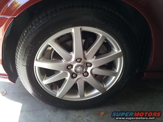 Close-up of a Jaguar wheel with a Pirelli tire. The wheel has a Jaguar logo in the center