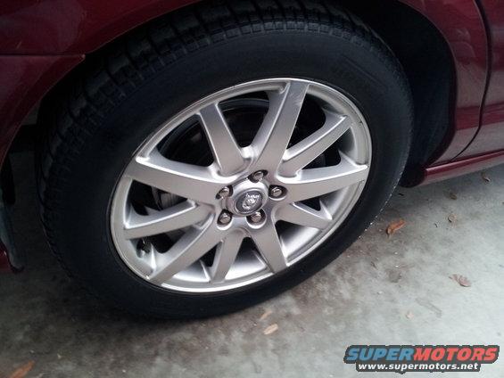 Close-up of a Jaguar S-Type wheel with a Jaguar logo in the center
