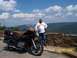 1982 Honda GL1100I GW Interstate - A man stands next to his black 1982 Honda GL1100I GW Interstate motorcycle on a scenic overlook.
