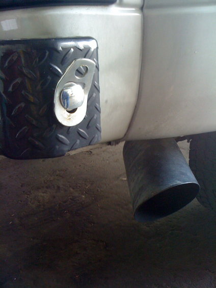 Rear bumper with diamond plate accent and large exhaust pipe