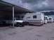 1997 Dodge 3500 - A white 1997 Dodge 3500 pickup truck is parked under a covered area, with multiple RVs behind it.