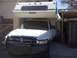 1997 Dodge 3500 - A white 1997 Dodge 3500 pickup truck is equipped with a Lance camper shell and a heavy-duty front bumper.