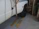 1997 Dodge 3500 - A white dually pickup truck is positioned on wooden ramps in what appears to be a garage or workshop.