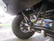 1974 Ford Bronco - Undercarriage view of a modified off-road vehicle's suspension system and winch cable.