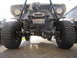 1974 Ford Bronco - A heavily modified off-road vehicle is shown from the front, with a winch mounted on its bumper.