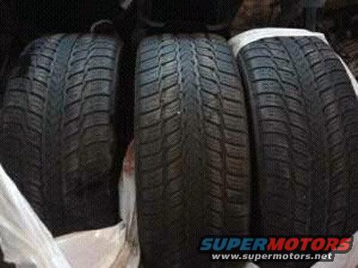 Three tires stacked, with white protective covers on the sides