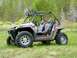 1970 Ford Bronco - Side-by-side ATV with roll cage and racing seats is parked outdoors in a natural setting.