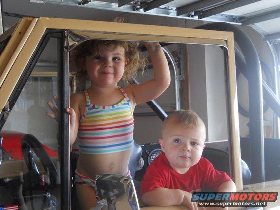 Two children inside a vehicle interior