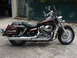 2006 Honda Shadow Aero - A maroon motorcycle with chrome accents and saddlebags is parked outdoors on a concrete surface.