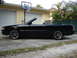 1992 Infiniti M30 - Side view of a black convertible parked in a driveway.