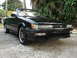 1992 Infiniti M30 - A black convertible, identified as a 1992 Infiniti M30, is parked outdoors on a paved surface.