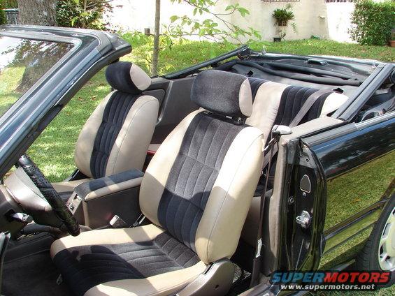 Interior of a convertible with two-tone seats and a black top