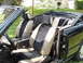 1992 Infiniti M30 - The interior of a black convertible shows tan and dark gray seats with a center console and door panel.