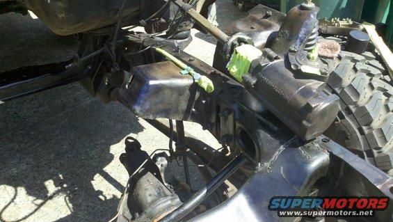 close-up of vehicle frame, suspension parts, and tire tread