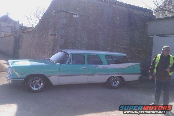 1957 Plymouth Belvedere wagon, turquoise and white, with a man in a yellow vest